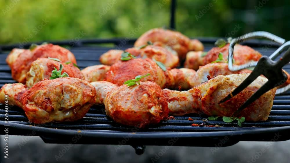 Spicy chicken leg with spices and herbs on grill Spicy chicken leg with spices and herbs on grill