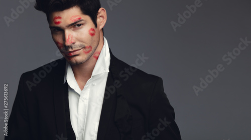 Photos Stylish man covered with kisses
