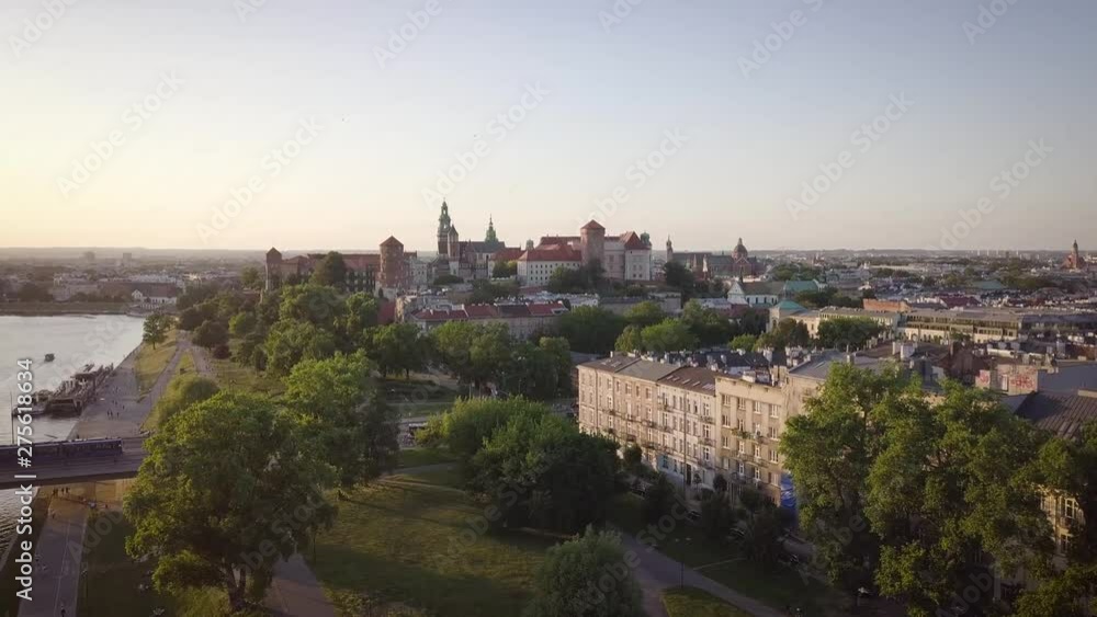 Skyline panorama of Krakow, Poland, with Royal Wawel Castle, Cathedral, Vistula River, bridge, harbor, ships and onboard restaurant. Aerial view in fall in sunset light. Skyline panorama of Krakow, Poland, with Royal Wawel Castle, Cathedral, Vistula River, bridge, harbor, ships and onboard restaurant. Aerial view in fall in sunset light.