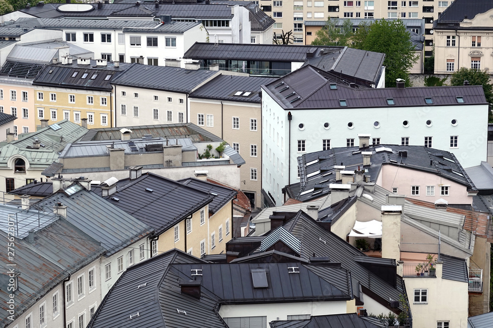 Top view of different buildings roofs with chimneys in typical european city Top view of different buildings roofs with chimneys in typical european city