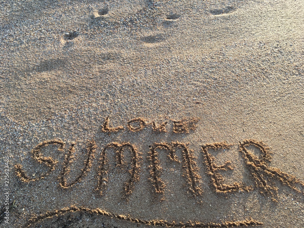 Fototapeta premium Summer - word summer wrote on the sand sunset beach