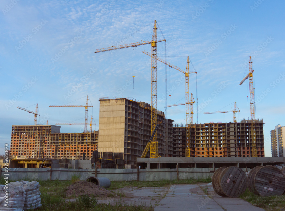 Construction of high-rise buildings. Building cranes and house frames