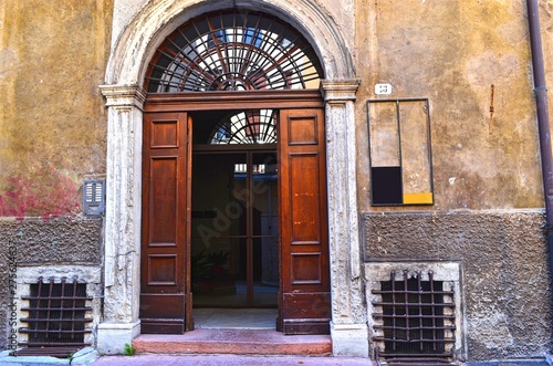 wooden open door with the entrance arch of the old building