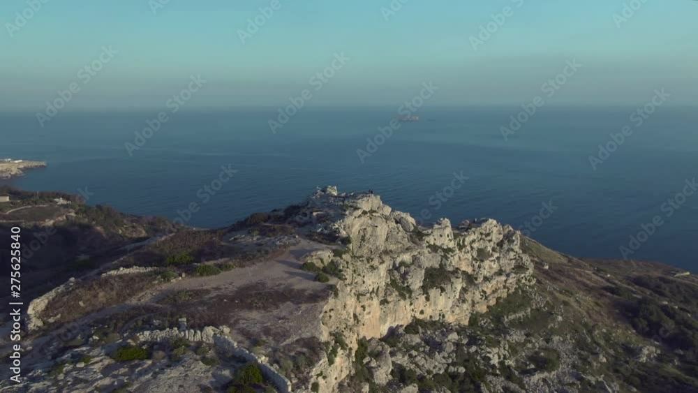 Epic view of Mediterranean sea and small Filfla uninhabited island from the Dingli cliffs, aerial drone orbiting shot Epic view of Mediterranean sea and small Filfla uninhabited island from the Dingli cliffs, aerial drone orbiting shot