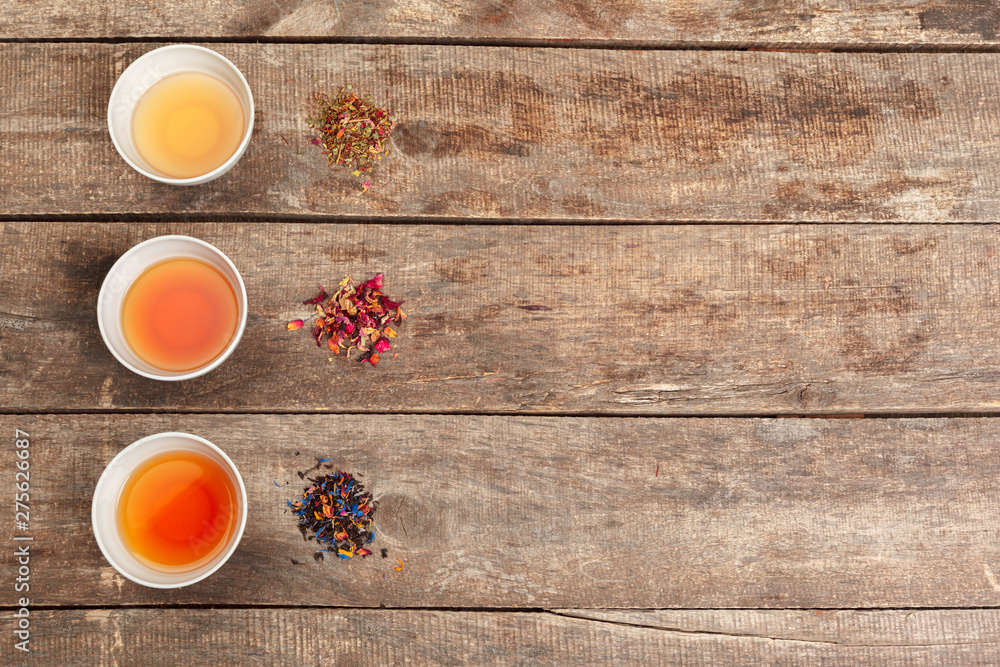 Collection of different teas in cups with tea leaves Collection of different teas in cups with tea leaves