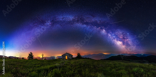 Fototapeta Naklejka Na Ścianę i Meble -  Make a wish - Meteor shower during summer with full arc of milky way. Beautiful Universe. Small chapel in foreground. Space background.