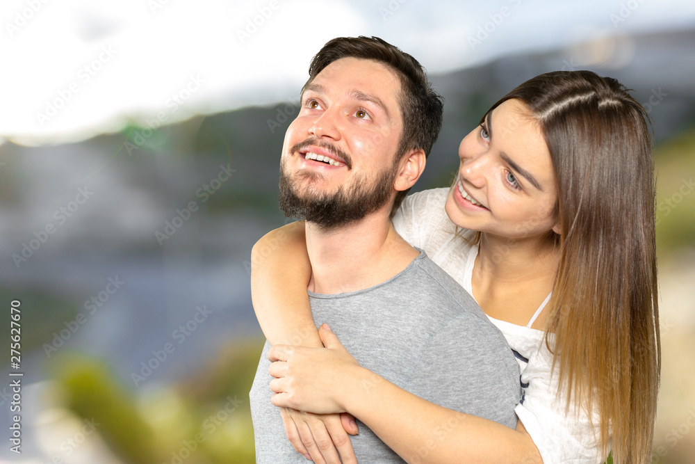 Happy couple embracing and looking at camera Happy couple embracing and looking at camera