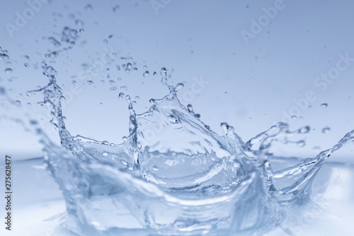 water splash isolated on blue background , 