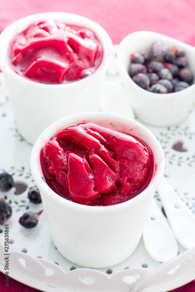 Blackcurrant sorbet in white cups, selective focus Blackcurrant sorbet in white cups, selective focus