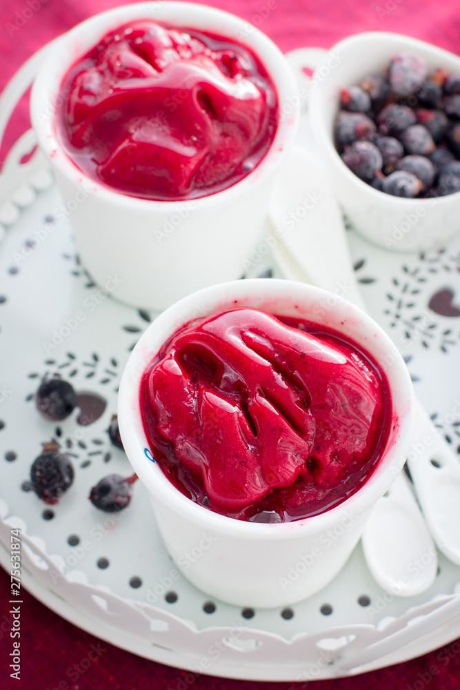 Blackcurrant sorbet in white cups, selective focus Blackcurrant sorbet in white cups, selective focus