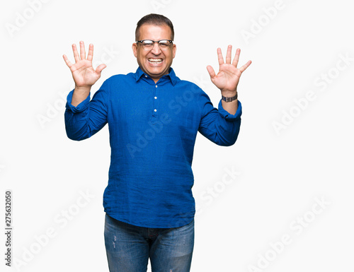 Middle age arab man wearing glasses over isolated background showing and pointing up with fingers number ten while smiling confident and happy.