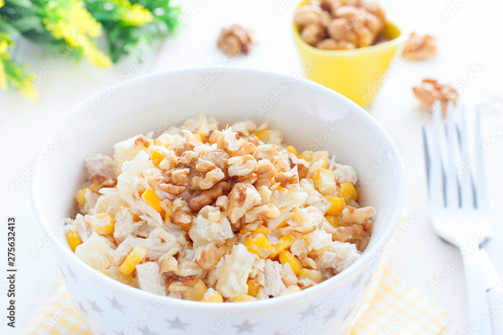 Salad with corn, chicken and pineapples in a white bowl, horizontal Salad with corn, chicken and pineapples in a white bowl, horizontal