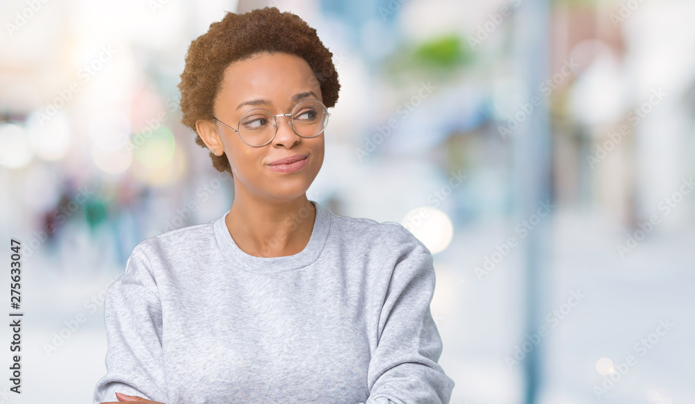 Young beautiful african american woman wearing glasses over isolated background smiling looking side and staring away thinking. Young beautiful african american woman wearing glasses over isolated background smiling looking side and staring away thinking.