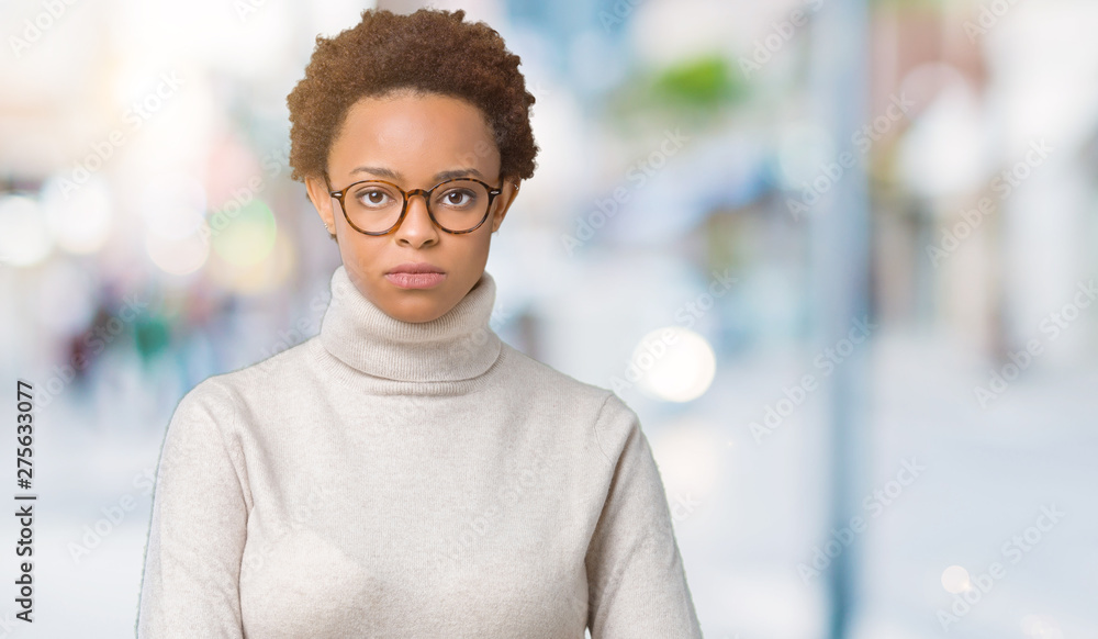 Obraz premium Young beautiful african american woman wearing glasses over isolated background skeptic and nervous, frowning upset because of problem. Negative person.