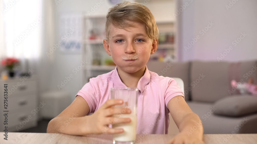 Boy drinking milk, calcium nutrition for healthy body and mind development Boy drinking milk, calcium nutrition for healthy body and mind development