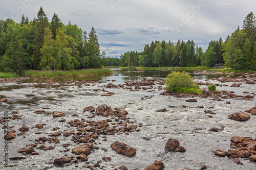 Scenic view of a river in summer before a rain. Farnebofjarden national park in Sweden photo