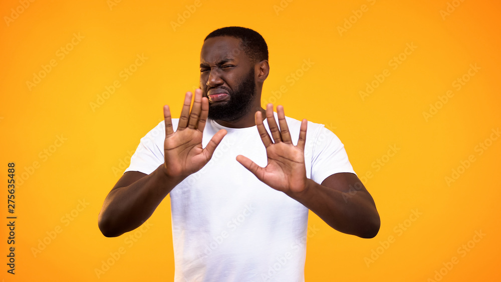Displeased young black guy showing rejection gesture, negative attitude, refuse - obrazy, fototapety, plakaty 