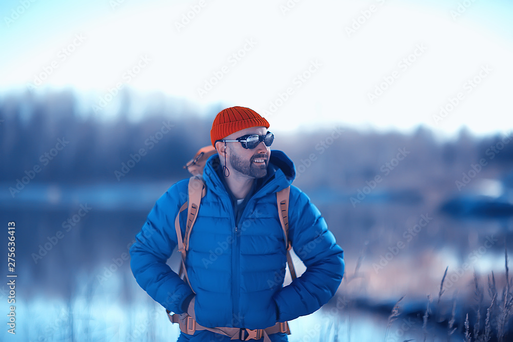 winter landscape man with a backpack / nature landscape a man on a hike with equipment in snowy weather in Canada