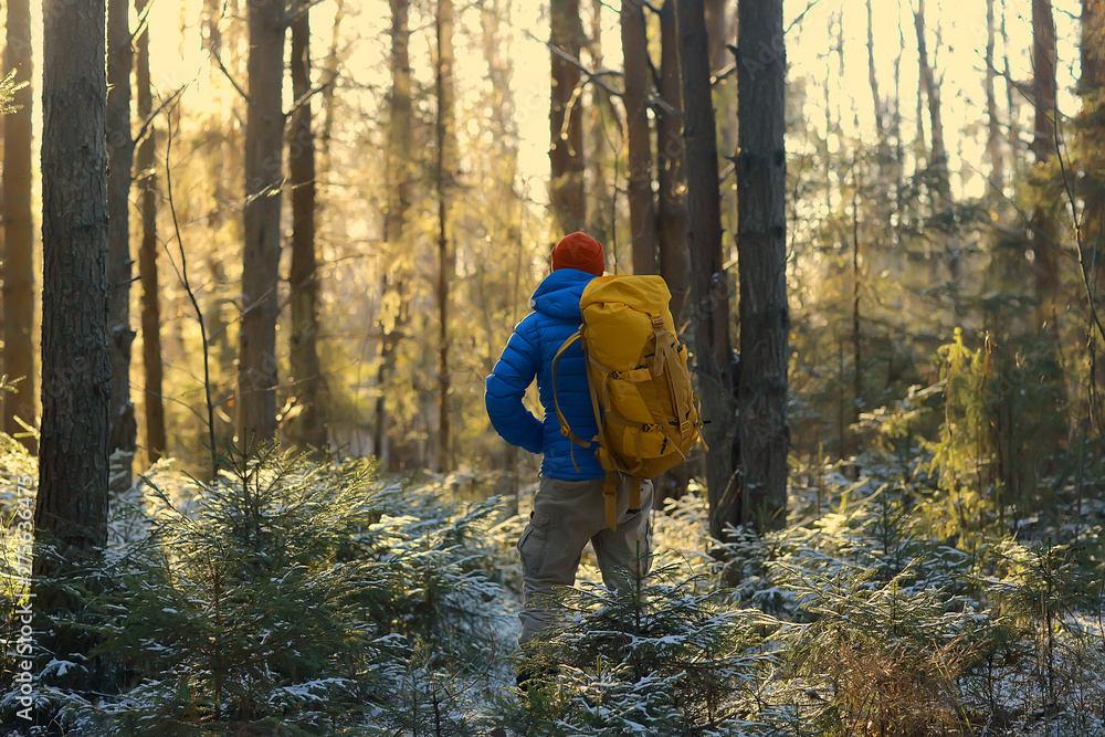 tourist in the winter forest / the guy travels against the backdrop of a winter landscape with forest, snow and trees tourist in the winter forest / the guy travels against the backdrop of a winter landscape with forest, snow and trees