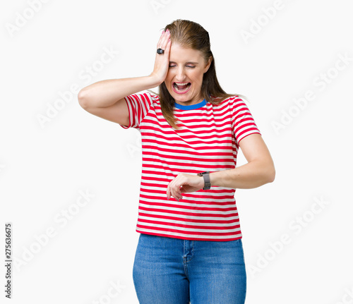 Middle age mature woman wearing casual t-shirt over isolated background Looking at the watch time worried, afraid of getting late