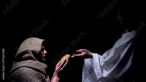 Mercy Jesus in crown of thorns giving bread for hungry homeless man, miracle