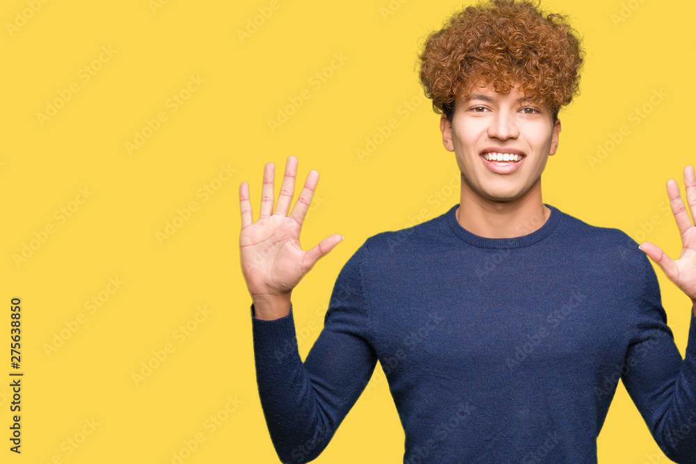 Young handsome man with afro hair showing and pointing up with fingers number ten while smiling confident and happy. Young handsome man with afro hair showing and pointing up with fingers number ten while smiling confident and happy.