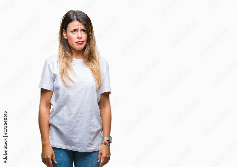 Young beautiful woman casual white t-shirt over isolated background skeptic and nervous, frowning upset because of problem. Negative person. Young beautiful woman casual white t-shirt over isolated background skeptic and nervous, frowning upset because of problem. Negative person.