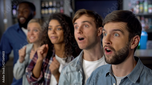 Excited match spectators shocked with favorite sport team victory entertainment