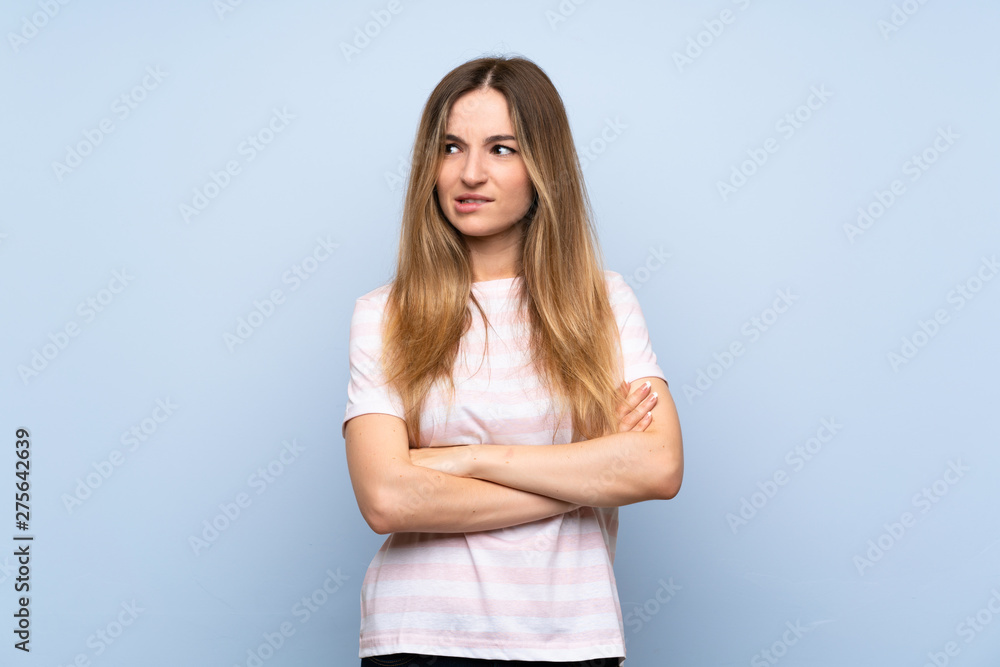 Young woman over isolated blue background with confuse face expression Young woman over isolated blue background with confuse face expression
