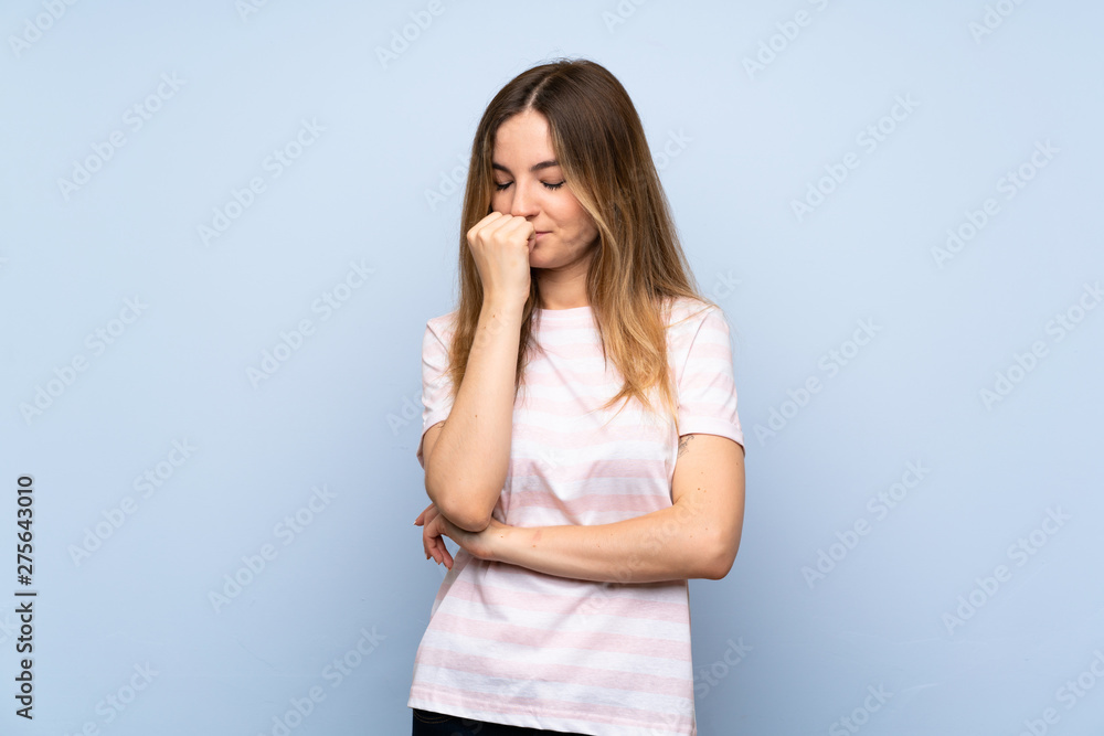 Young woman over isolated blue background having doubts Young woman over isolated blue background having doubts