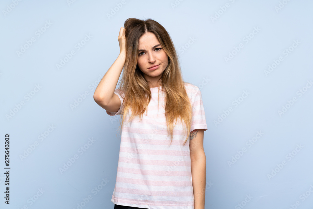 Young woman over isolated blue background with an expression of frustration and not understanding Young woman over isolated blue background with an expression of frustration and not understanding