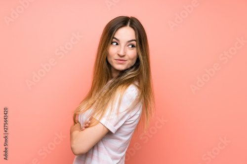 Young woman over isolated pink wall laughing