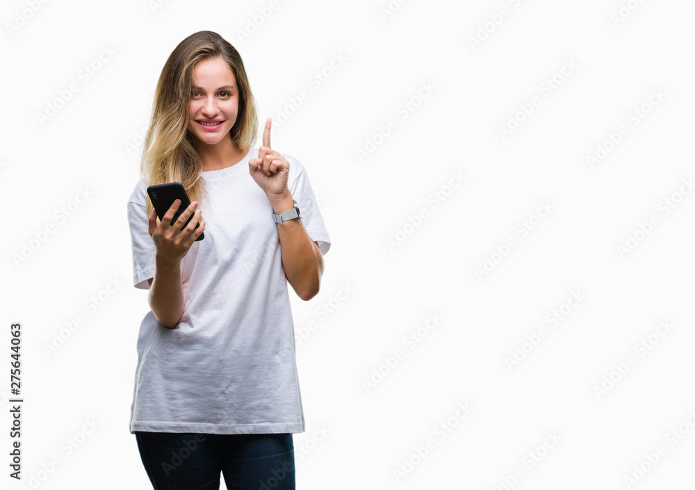 Young beautiful blonde woman using smartphone over isolated background surprised with an idea or question pointing finger with happy face, number one