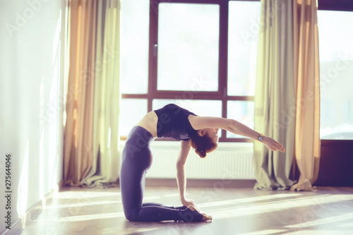 Fototapeta Naklejka Na Ścianę i Meble -  girl athlete doing bridge / yoga, professional gymnast, stretching and yoga trainer