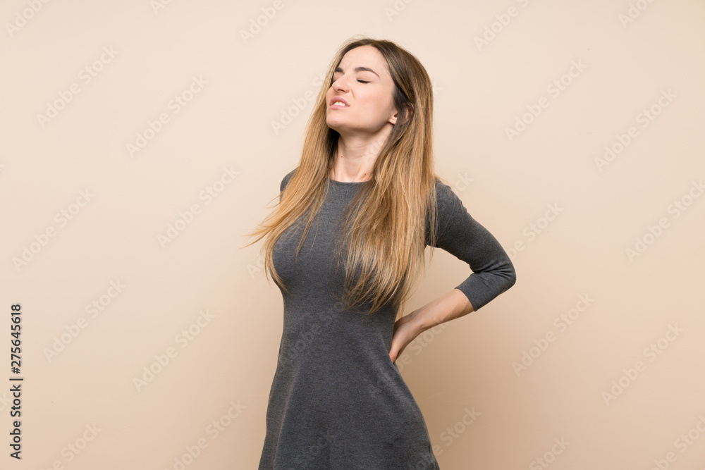 Fototapeta premium Young woman over isolated background suffering from backache for having made an effort