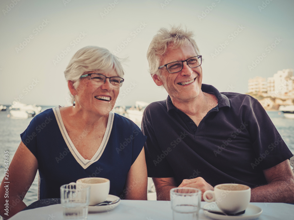 Retired couple enjoying coffee on a resort Retired couple enjoying coffee on a resort