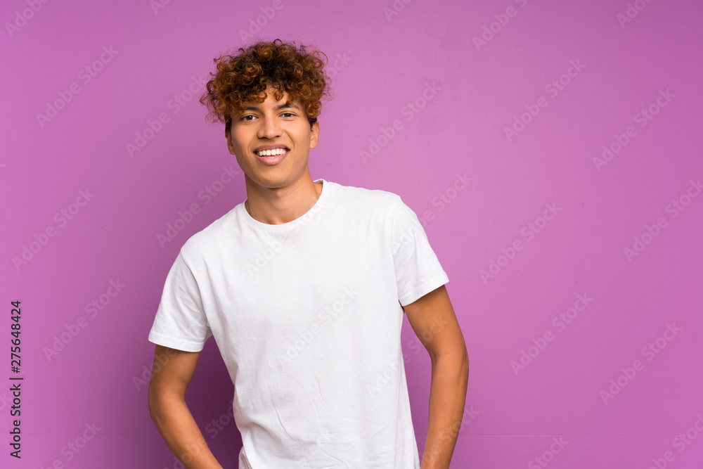 Young african american man over isolated purple wall laughing Young african american man over isolated purple wall laughing
