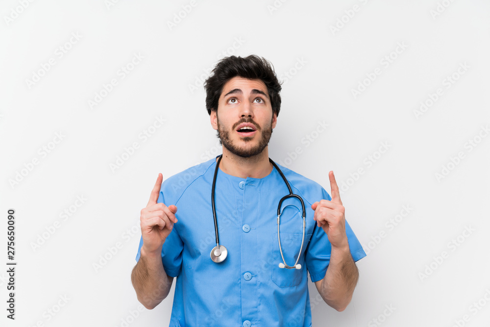 Surgeon doctor man over isolated white wall pointing with the index finger a great idea Surgeon doctor man over isolated white wall pointing with the index finger a great idea