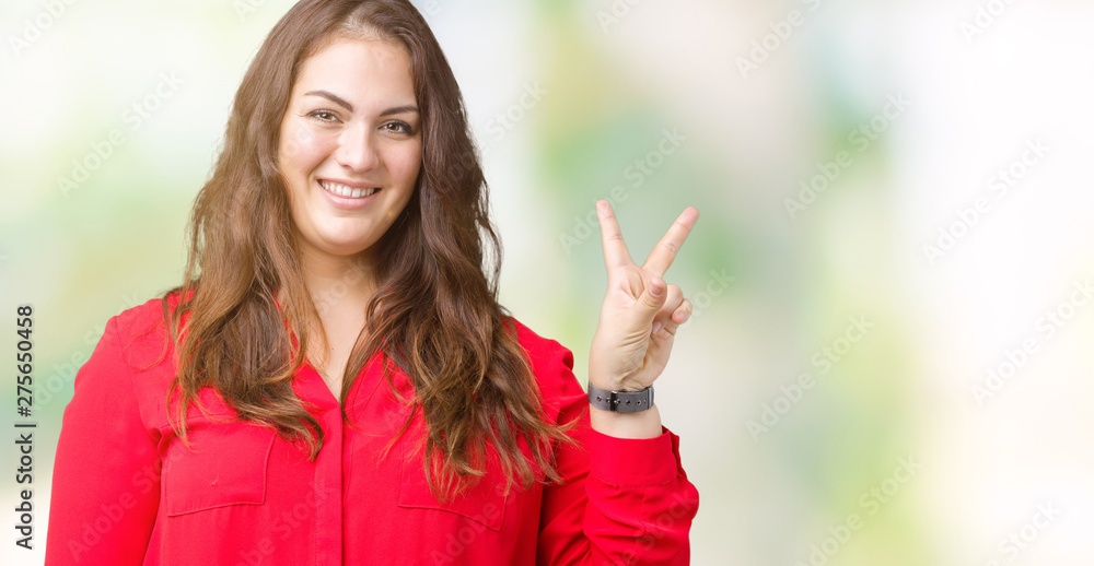 Beautiful plus size young business woman over isolated background smiling with happy face winking at the camera doing victory sign. Number two. Beautiful plus size young business woman over isolated background smiling with happy face winking at the camera doing victory sign. Number two.