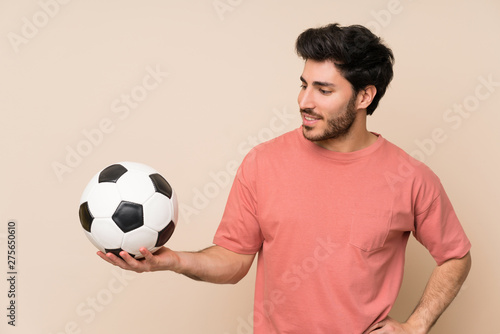 Handsome man holding a soccer ball