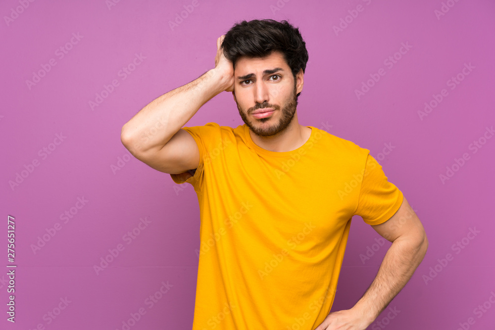 Handsome over isolated purple wall with an expression of frustration and not understanding Handsome over isolated purple wall with an expression of frustration and not understanding