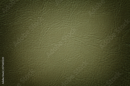 Dark olive leather texture background, closeup. Green cracked backdrop