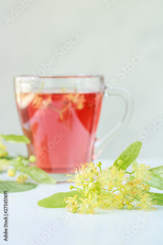 linden flowers with a brewed linden tea in the background