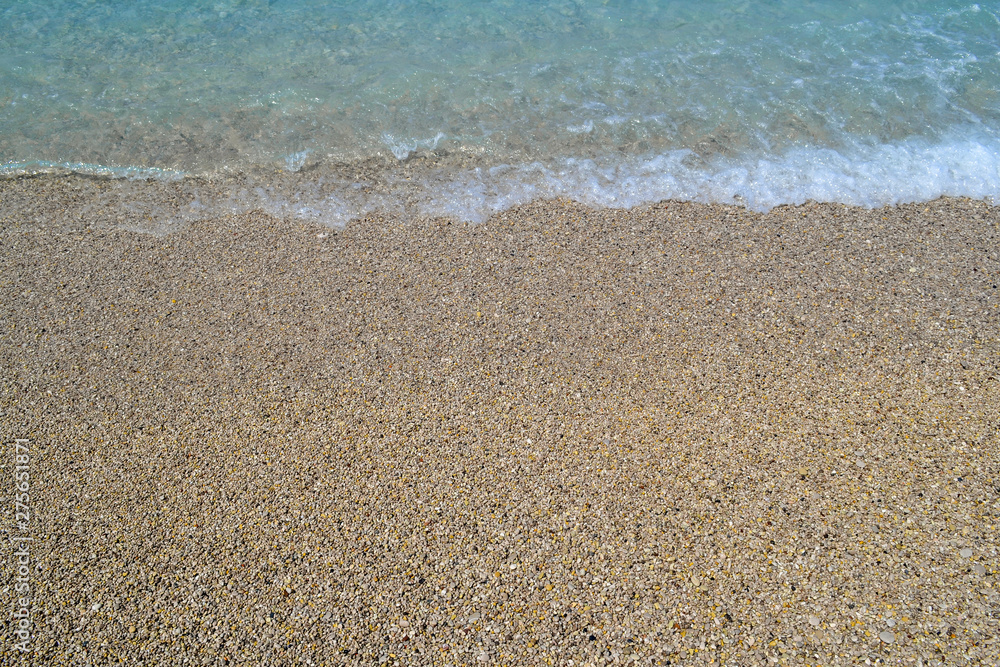 Sea wave on the shore of a pebble beach, water, foam, background Sea wave on the shore of a pebble beach, water, foam, background