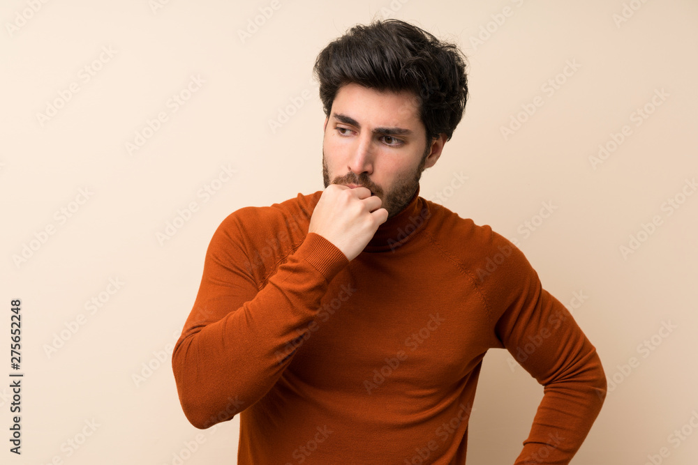 Handsome over isolated wall having doubts Handsome over isolated wall having doubts