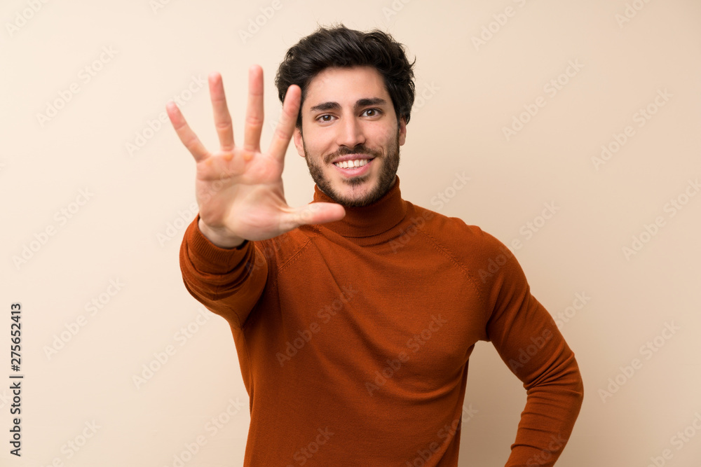 Fototapeta premium Handsome over isolated wall counting five with fingers