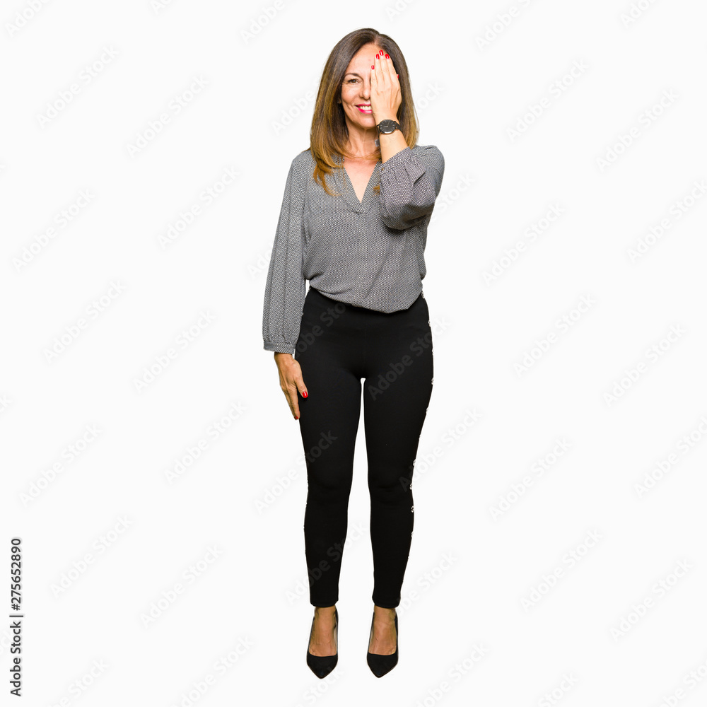 Beautiful middle age business woman covering one eye with hand with confident smile on face and surprise emotion. Beautiful middle age business woman covering one eye with hand with confident smile on face and surprise emotion.