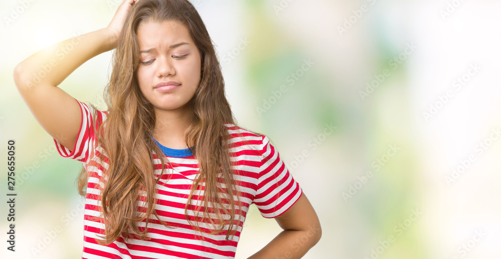 Young beautiful brunette woman wearing stripes t-shirt over isolated background confuse and wonder about question. Uncertain with doubt, thinking with hand on head. Pensive concept.