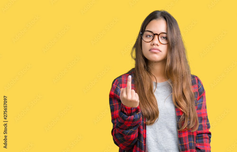 Young beautiful brunette woman wearing jacket and glasses over isolated background Showing middle finger, impolite and rude fuck off expression
