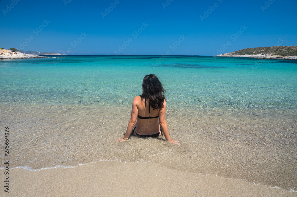 Beautiful woman enjoyin in the amazing bay and beach on Antiparos Island in Cyclades, greece Beautiful woman enjoyin in the amazing bay and beach on Antiparos Island in Cyclades, greece